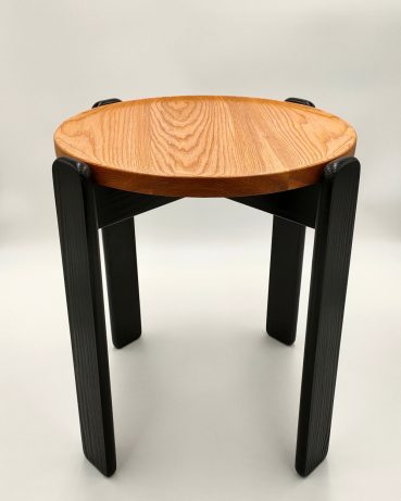 Contemporary solid wood side table with a round Elm top and dark timber legs. Designed and made in Edinburgh