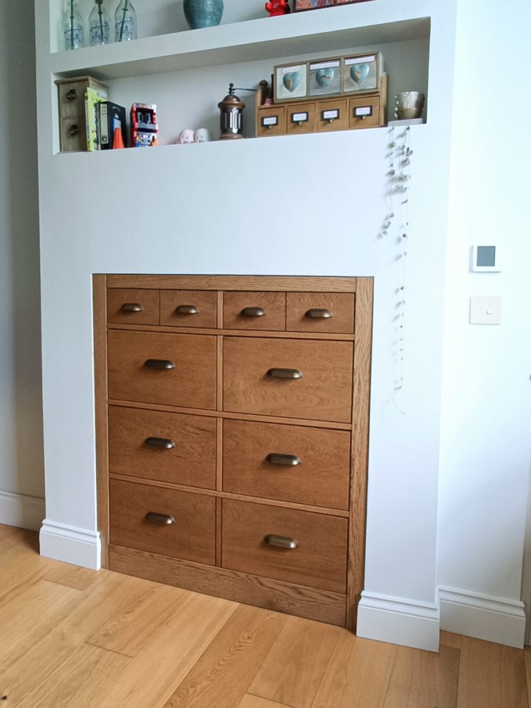 Bespoke solid oak chest of drawers built into an alcove